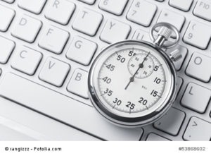 Close up of analog stopwatch on a keyboard